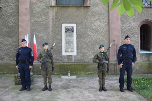 na zdjęciu policjanci i żołnierze w trakcie warty honorowej pod pamiątkową tablicą
