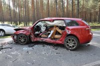 zdjęcie przedstawia rozbity samochód osobowy. Pojazd nie ma drzwi od strony kierowcy i siedzącego za nim pasażera