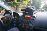 fotografia kolorowa: na fotografii widać wnętrze policyjnego radiowozu. Przez przednią szybę widać  ulicę i jadące nią samochody osobowe