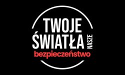 Grafika: ciemne tło, na środku którego widnieje napis „Twoje światła – Nasze bezpieczeństwo”