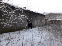 Na zdjęciu widać policjanta, który wchodzi do opustoszałego budynku.