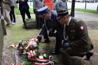 Na zdjęciu widać Komendanta Powiatowego Policji w Tarnowskich Górach młodszego inspektora Sławomira Bylickiego oraz przedstawicieli wojska i straży pożarnej. Mundurowi składają wiązanki pod tablicą upamiętniającą „Poległych Powstańców Ziemi Tarnogórskiej”.