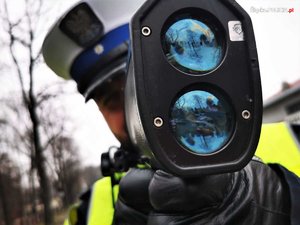 policjant z policyjnym urządzeniem do pomiaru prędkości