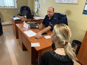 policjant i kobieta przy biurku