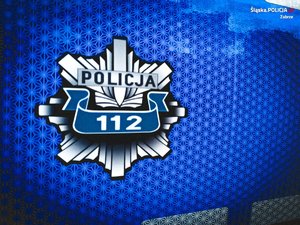 na zdjęciu policyjna odznaka z numerem 112