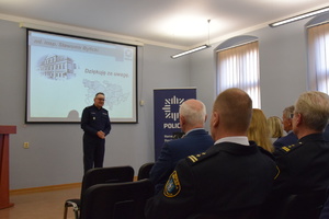 na zdjęciu zastępca komendanta wojewódzkiego policji w katowicach w trakcie przemówienia w centralnej części sali odpraw