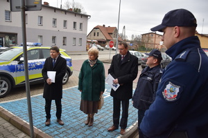na zdjęciu policjanci, burmistrz miasta kalety oraz przewodnicząca rady miasta oraz radny powiatu, za nimi nowy radiowóz