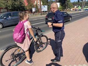 na zdjęciu policjant a obok niej rowerzystka na drodze rowerowej