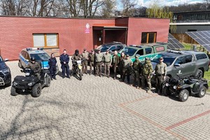 na zdjęciu policjanci i strażnicy leśni przy pojazdach