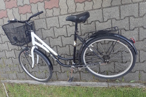 na zdjęciu leżący rower na chodniku
