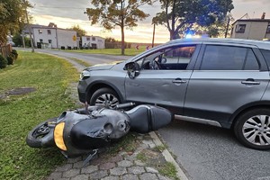 na zdjęciu motocykl leżący przy nieoznakowanym radiowozie