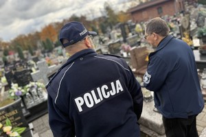 na zdjęciu zastępca komendanta i kapelan Policji przy grobie na cmentarzu