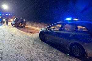 na zdjęciu radiowóz policyjny a przed nim rozbity samochód na jezdni