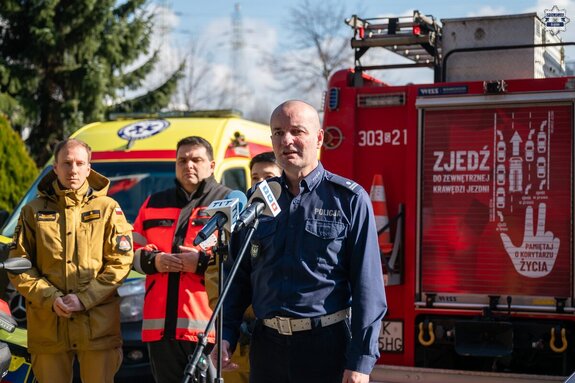 na zdjęciu policjant przy mikrofonie
