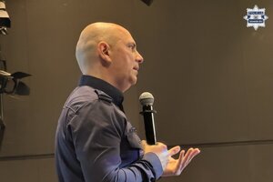 na zdjęciu policjant z mikrofonem
