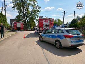na zdjęciu skrzyżowanie, na którym stoi radiowóz i wozy strażackie